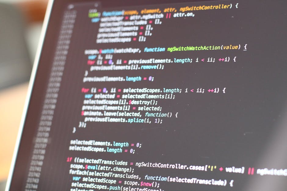 A close-up of a computer screen displaying lines of colorful programming code with syntax highlighting, including keywords, variables, and functions in various colors such as pink, blue, green, and ye